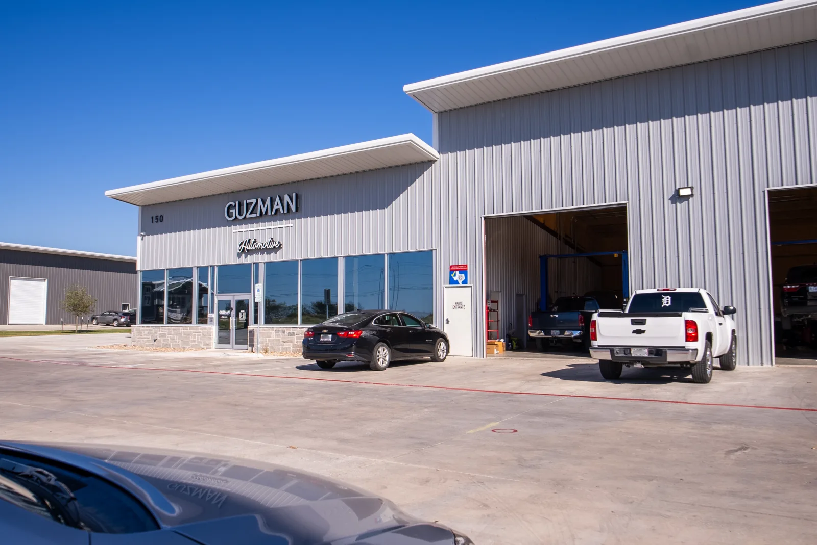 Guzman Automotive shop exterior with signage, in Taylor & Hutto, TX