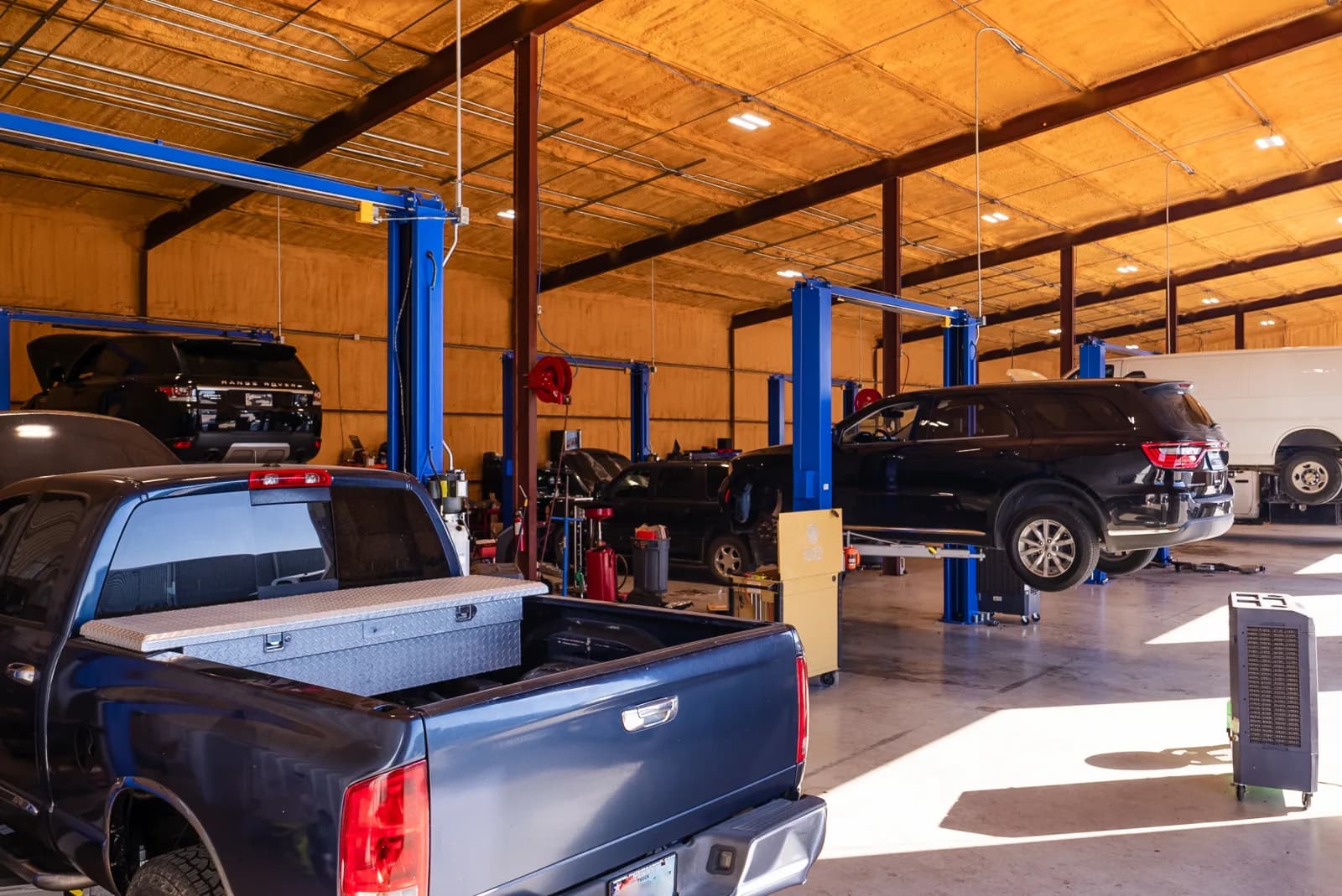 Vehicle on a lift at Guzman Automotive for brake service
