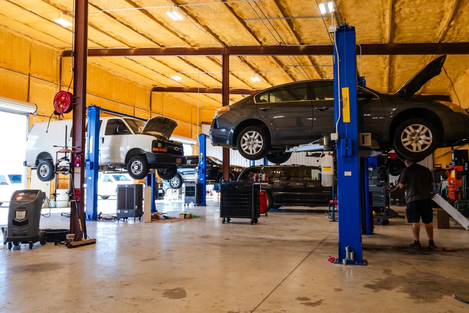 Guzman Automotive shop bay with vehicles on lifts