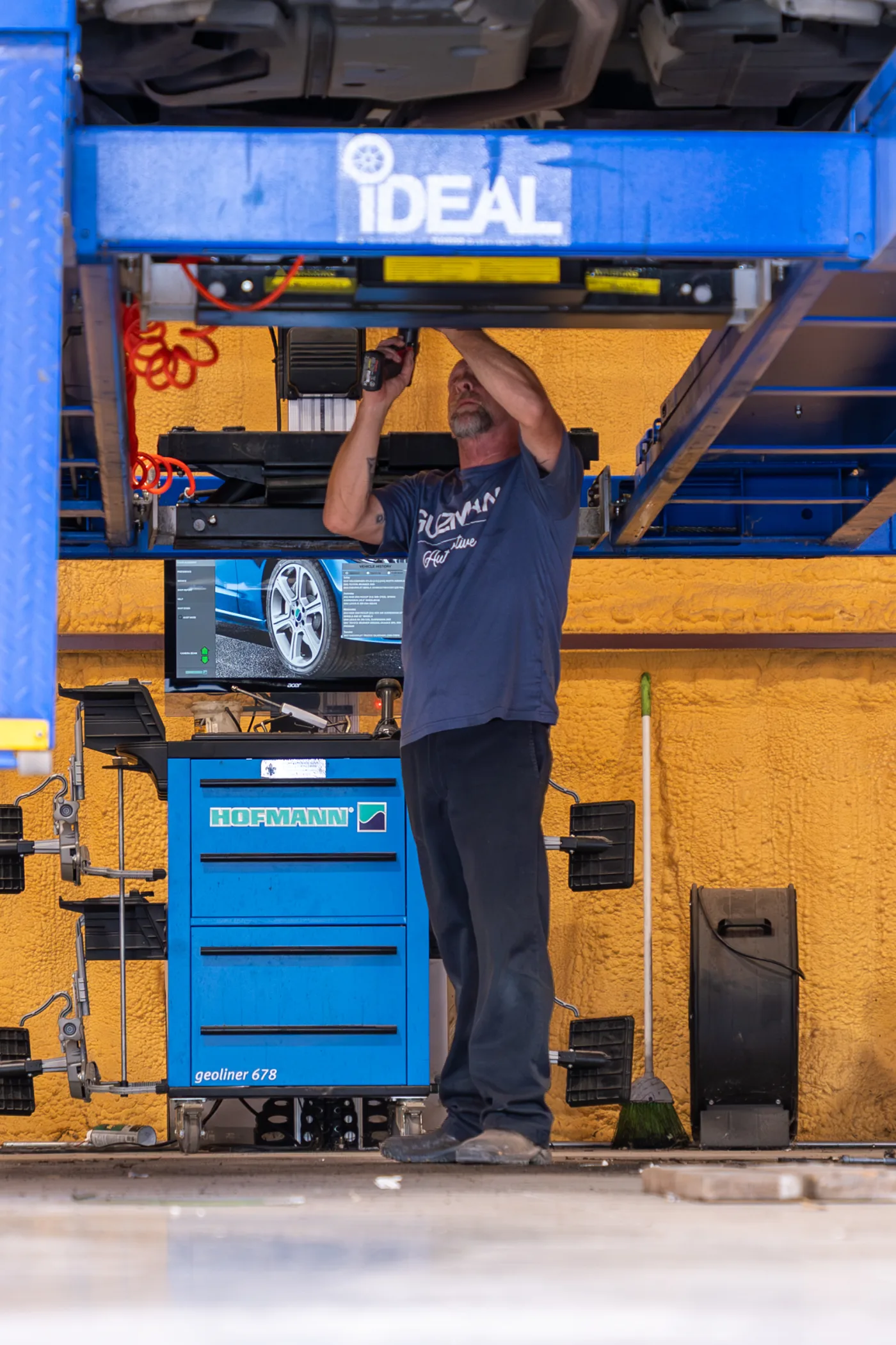 Guzman Automotive technician running vehicle diagnostics