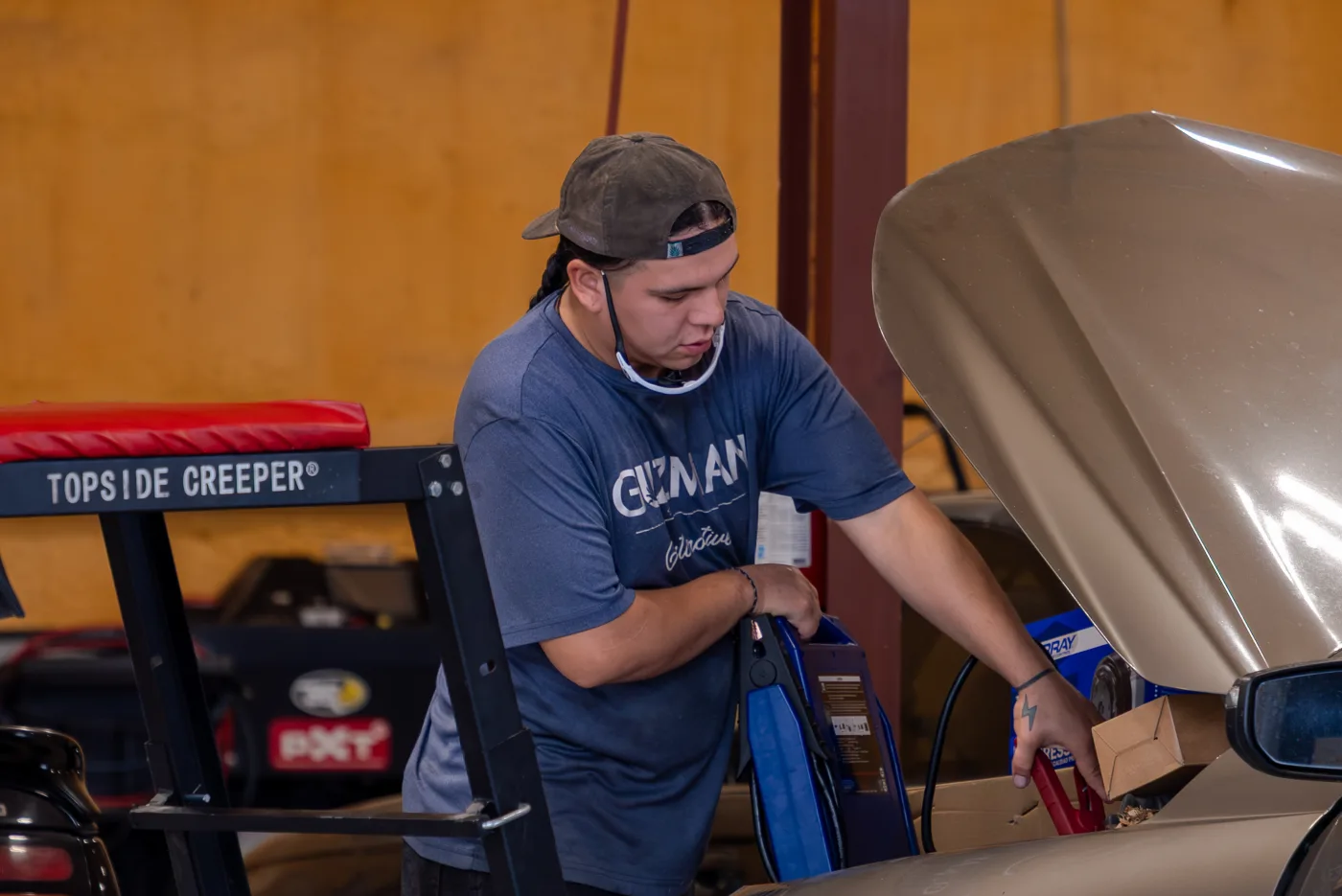 Guzman Automotive technician working on a vehicle's transmission