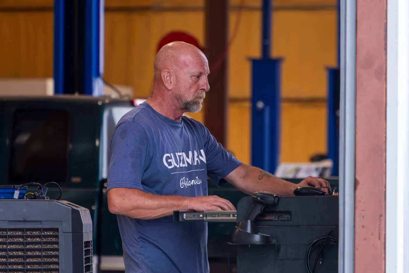 Guzman Automotive technician running vehicle diagnostics